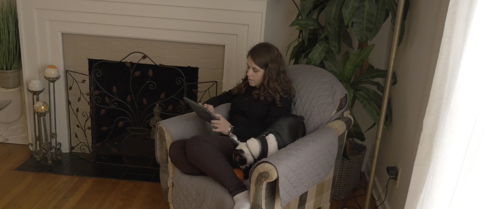 Jordyn in an armchair with communication device